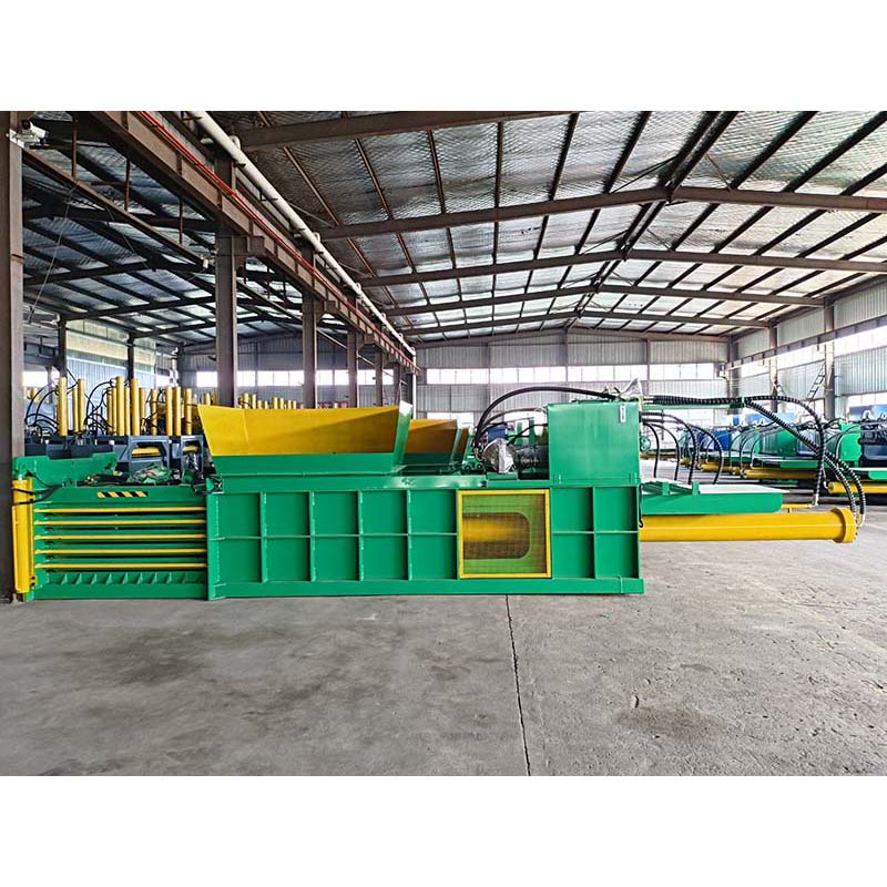 Horizontal baler for industrial-scale recycling and waste processing.