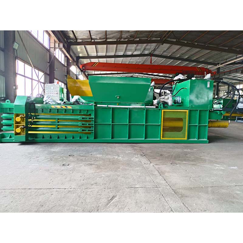 Horizontal cardboard baler for large volume, efficient recycling operations.