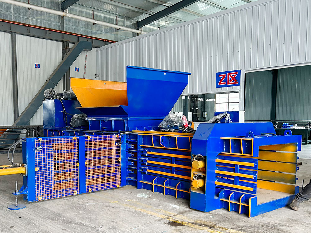 Horizontal baler machine for compressing waste materials.