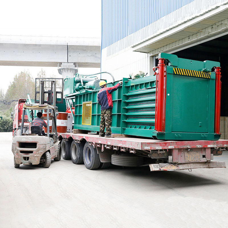 Efficient horizontal cardboard baler for recycling.