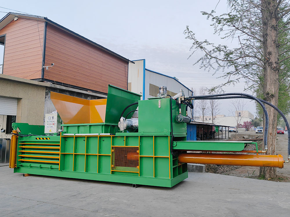 Horizontal baler for compacting cardboard, plastics, and paper waste.