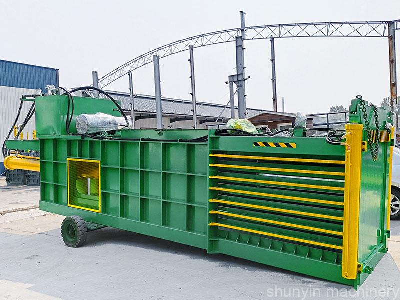 Horizontal cardboard baling machine designed for heavy-duty waste compression.