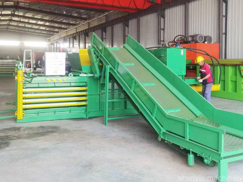 Industrial horizontal baler designed for large-volume waste compression operations.