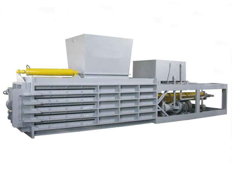 Horizontal auto-tie baler for automatic material bundling and secure packaging.  