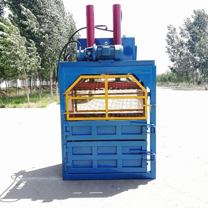 Industrial vertical baler for optimizing recycling and material compression.