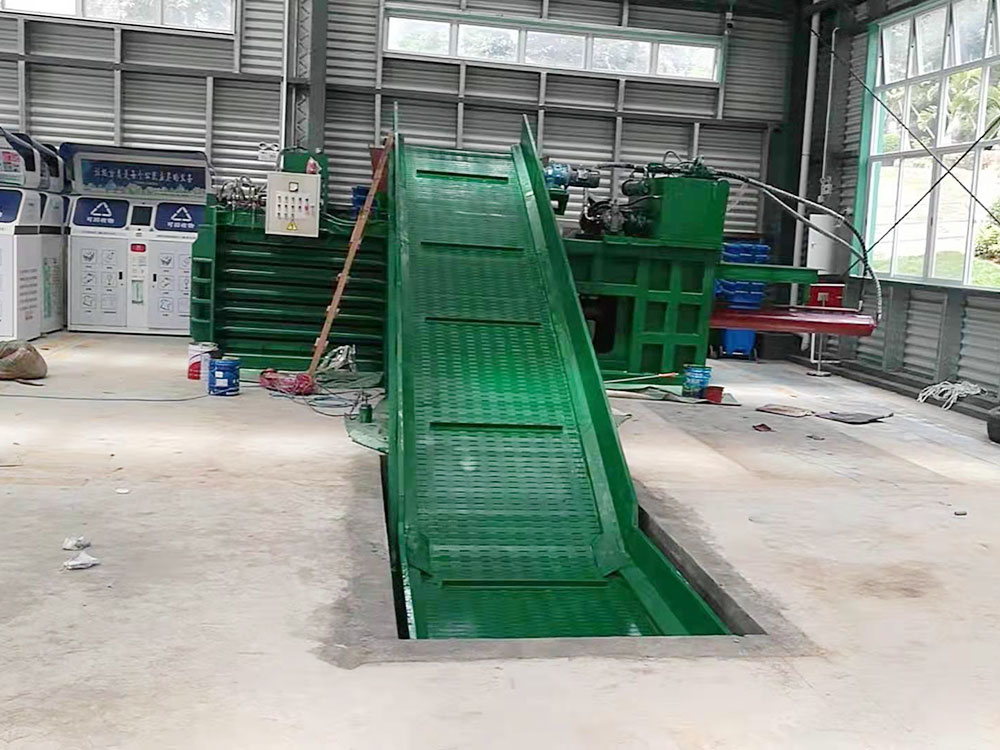 Closed end horizontal baler for safer waste baling operations.