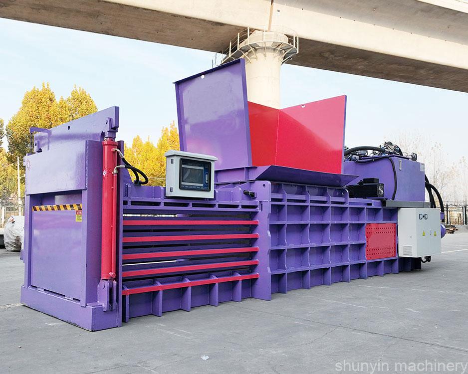 Horizontal cardboard baler designed for heavy-duty material compression.