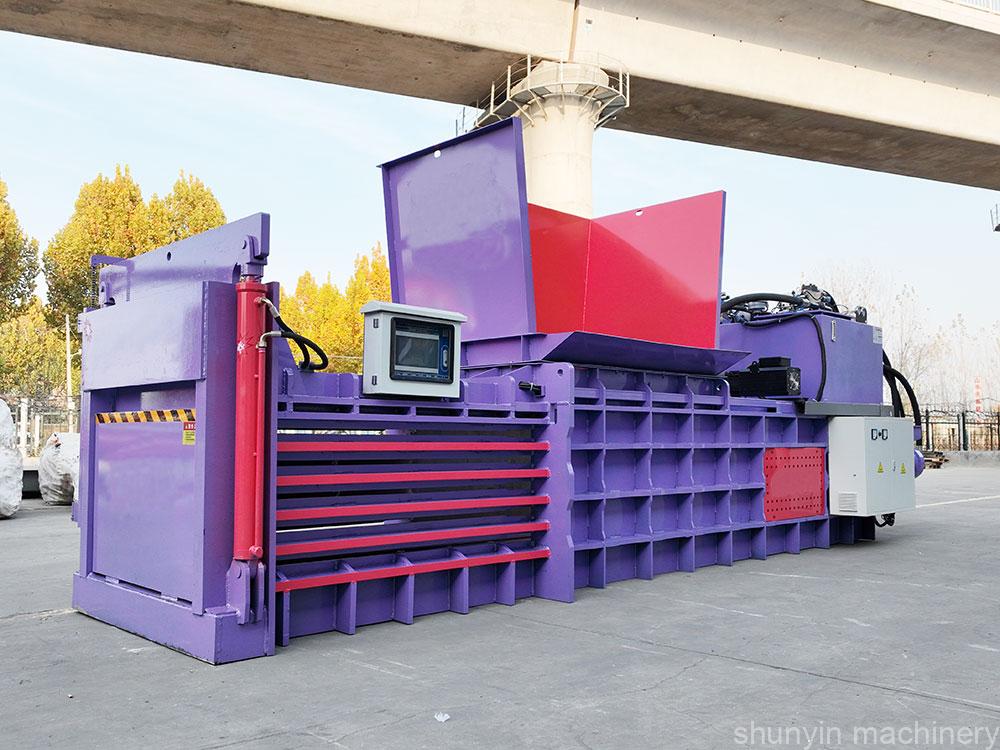 Horizontal baling machine for compacting recyclables in bulk efficiently.