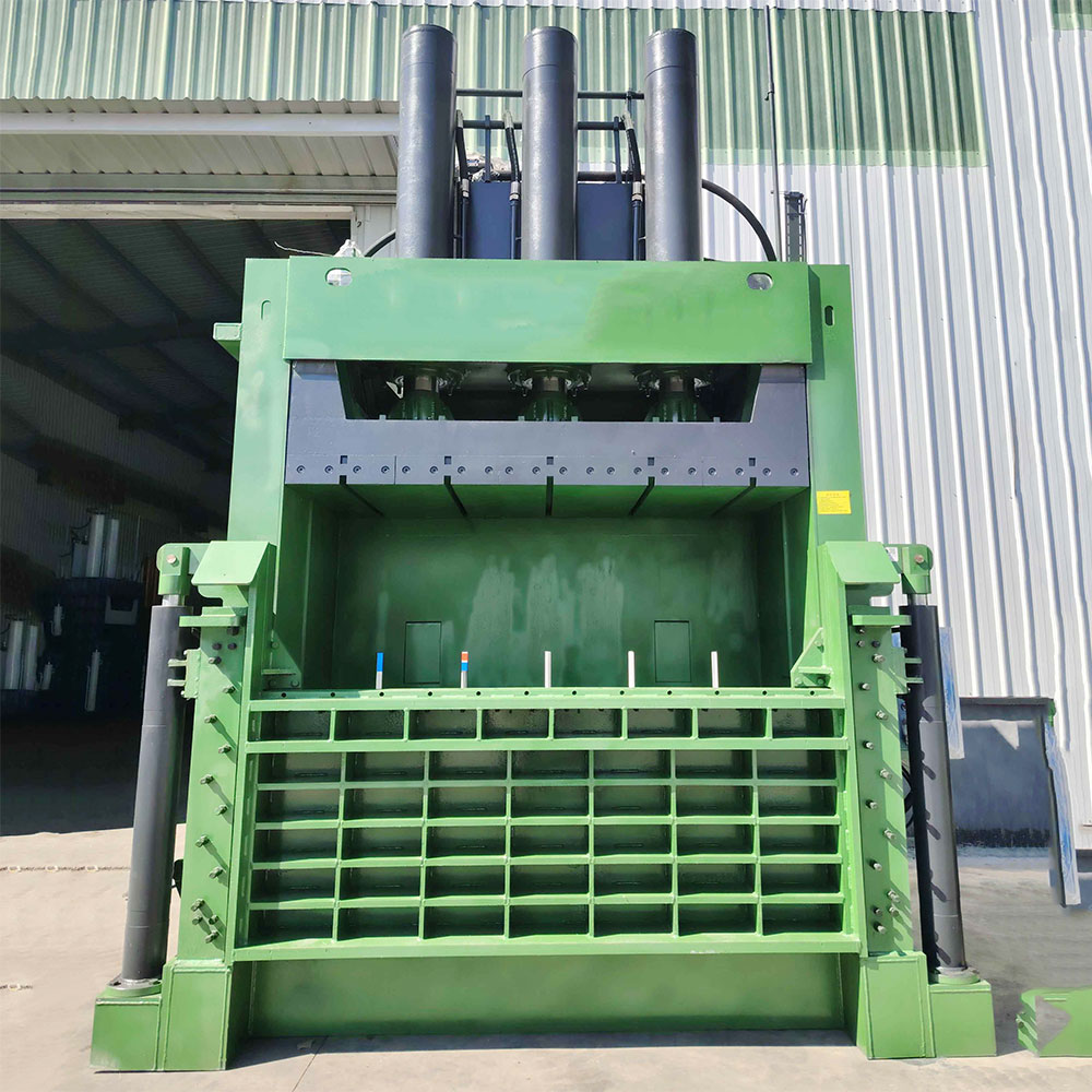 Vertical cardboard baler for recycling in small to large facilities.