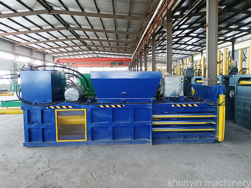 Efficient horizontal recycling compactor machine for large-scale operations.