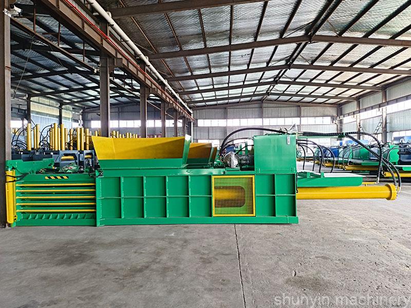 High-capacity horizontal baling machine designed for paper recycling.