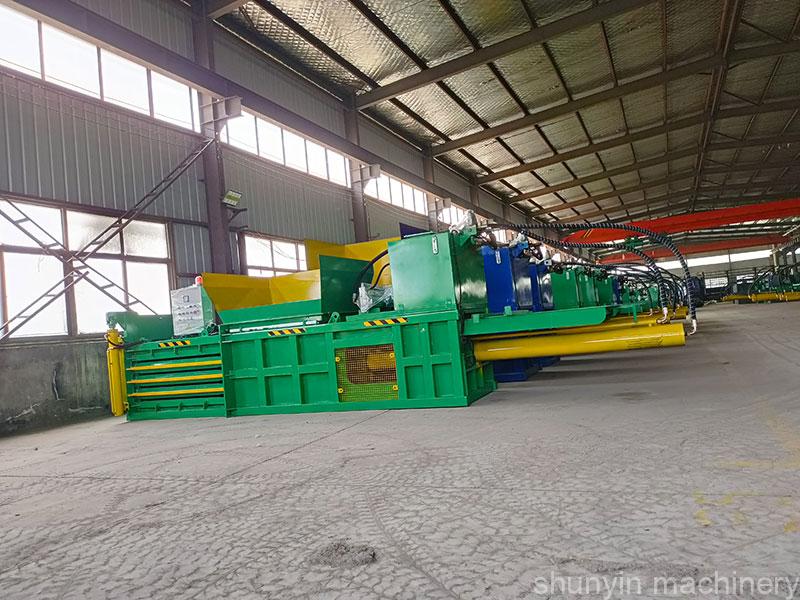 Shunyin's horizontal baler efficiently compresses bulky cardboard waste.