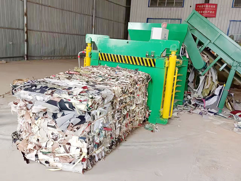 Horizontal baler machine for high-efficiency waste compaction and recycling.