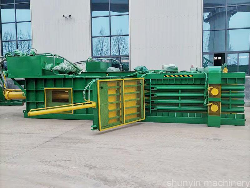 Horizontal waste compaction baler for industrial waste management