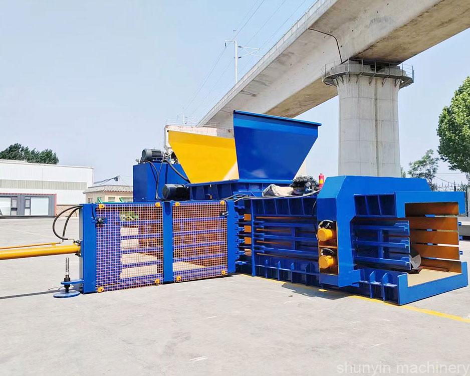 Horizontal baler for compacting a variety of recyclable materials.