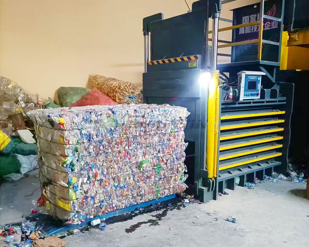 Horizontal baling machine for paper waste processing and recycling.