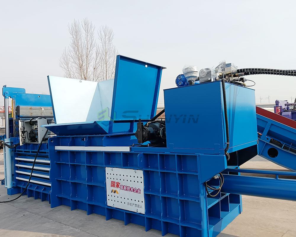 Horizontal baling machine designed to compress metals for recycling.