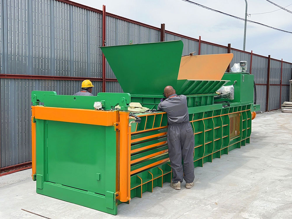 hydraulic baler compressing cardboard