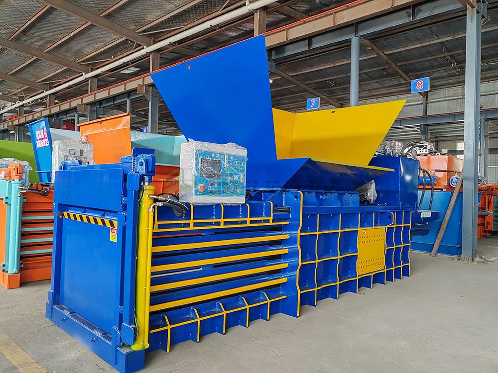 Semi-automatic horizontal baler machine operating in winter warehouse