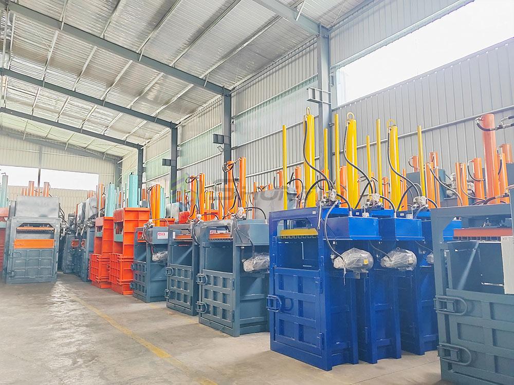 Industrial vertical baler machine compacting cardboard and recyclables