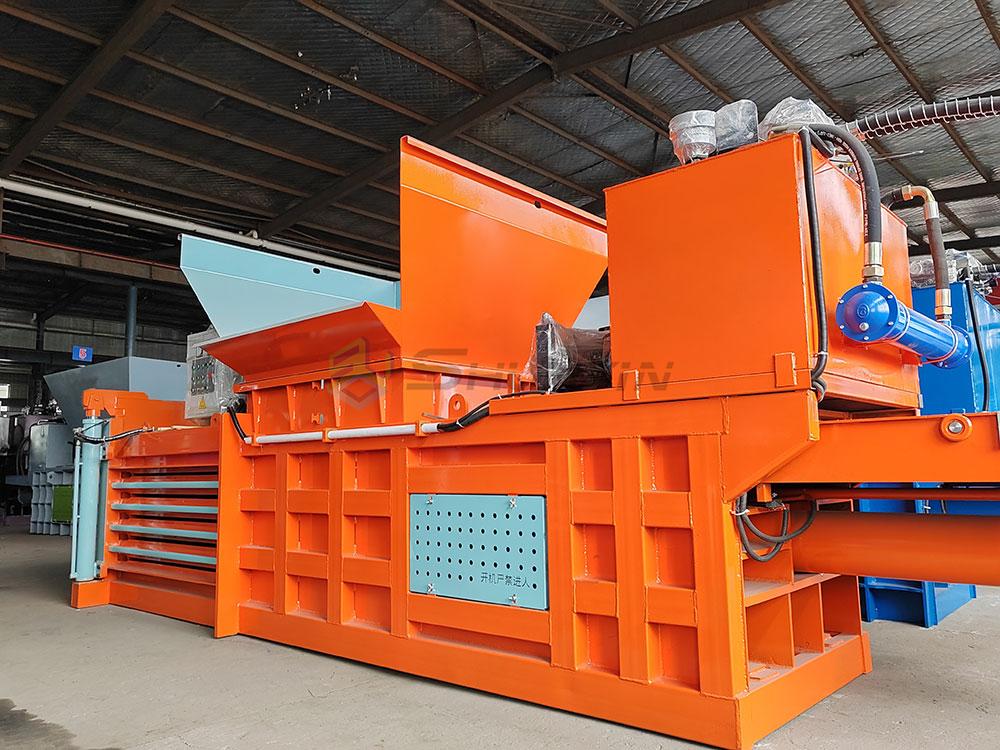 Horizontal baler with a high-capacity chamber for large-scale material compaction.