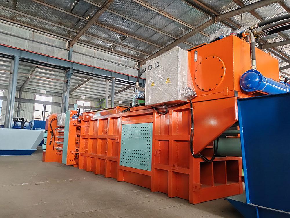 Robust horizontal baler designed for scrap metal and material compaction.