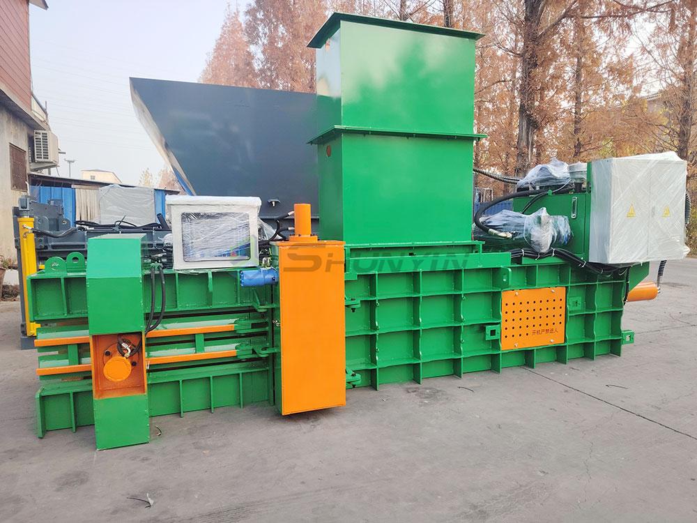 sorted plastic waste entering baler conveyor system