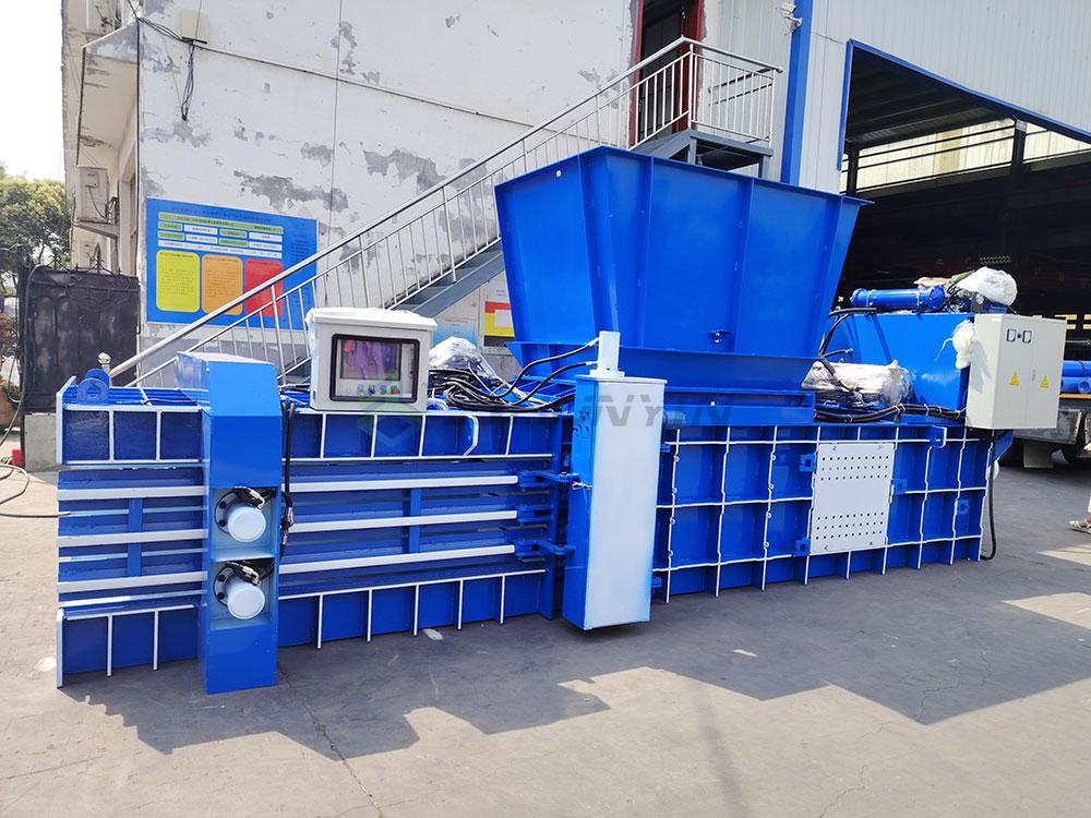 stationary compactor crushing municipal solid waste