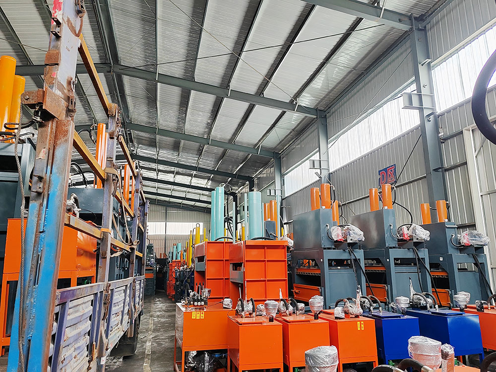 demolition site workers operating baler for concrete wood separation