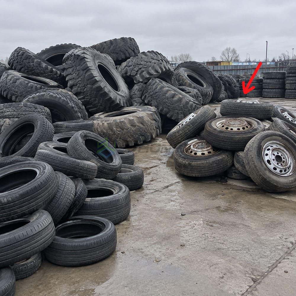 Sorting tires by type for baling Tire piles awaiting compression