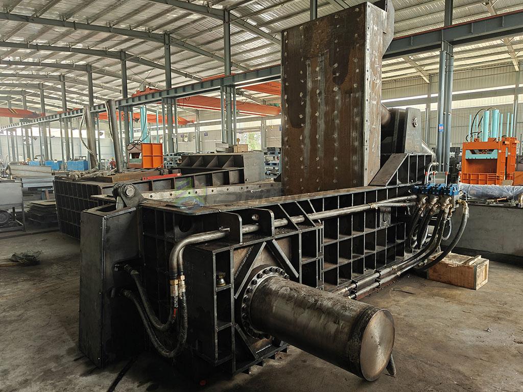 Scrap baler compresses materials into compact bales or blocks